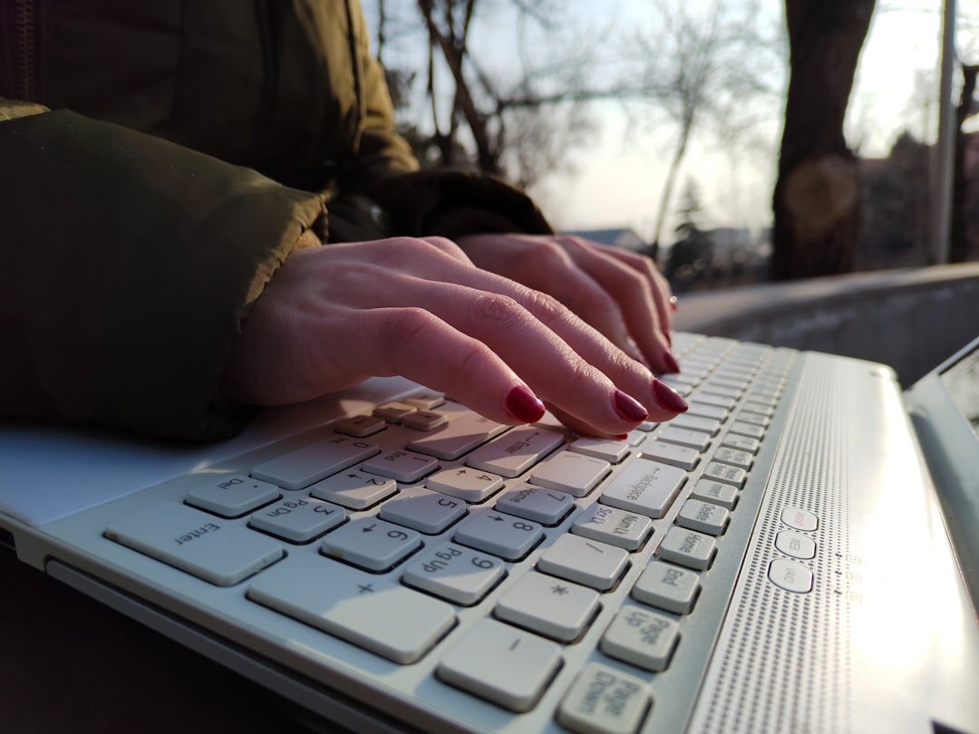 writer typing on laptop