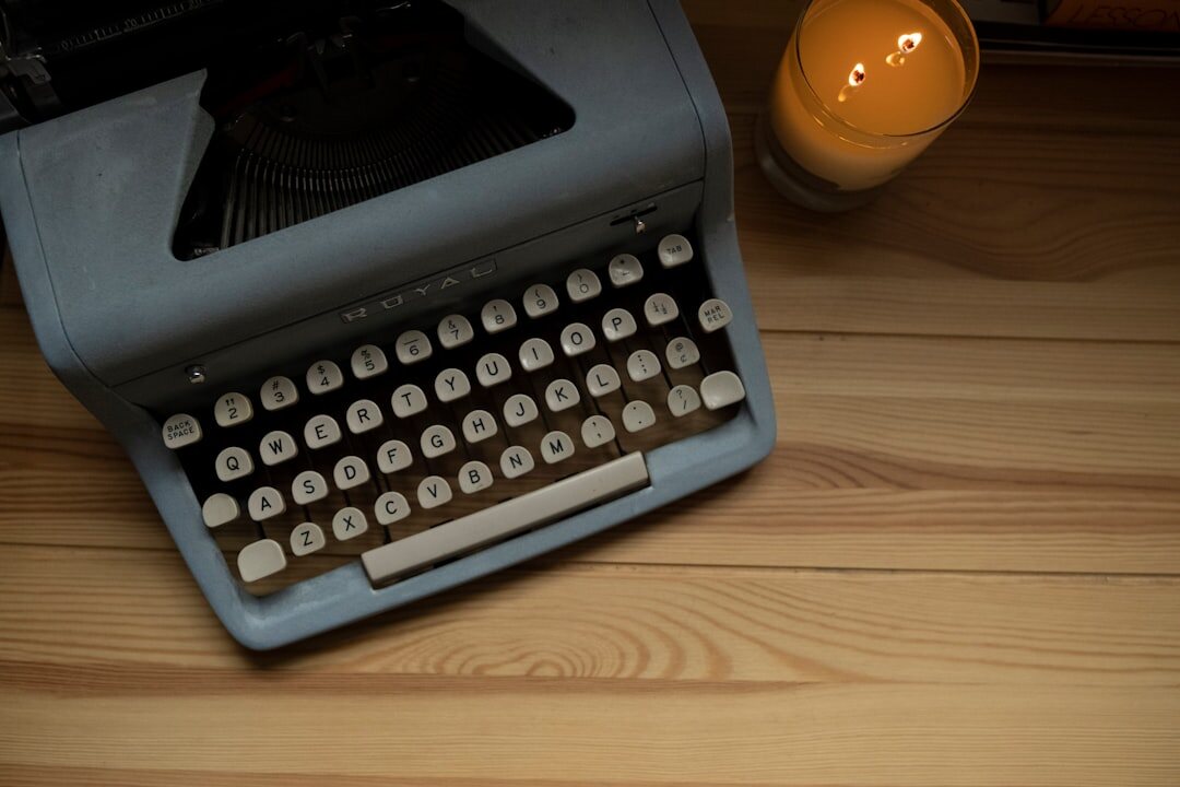Vintage typewriter on a wooden desk with coffee cup and papers