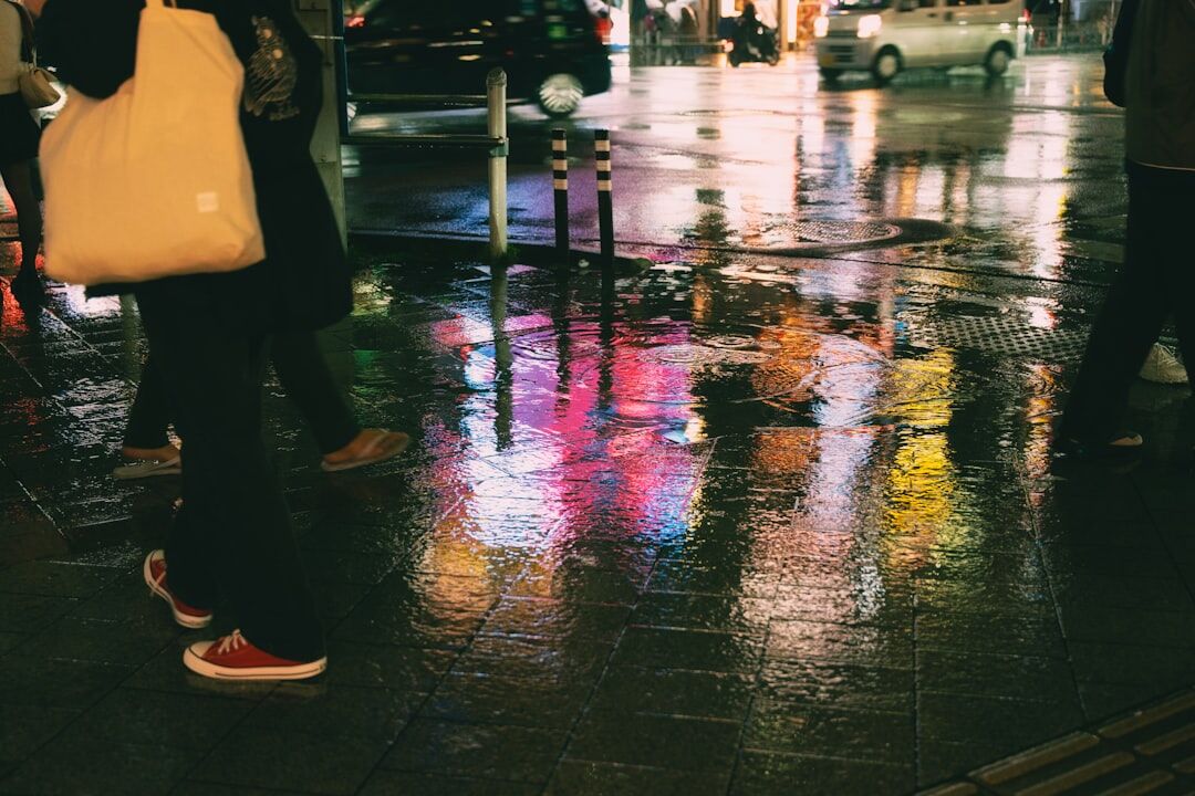Rainy city street at night with reflections on wet pavement